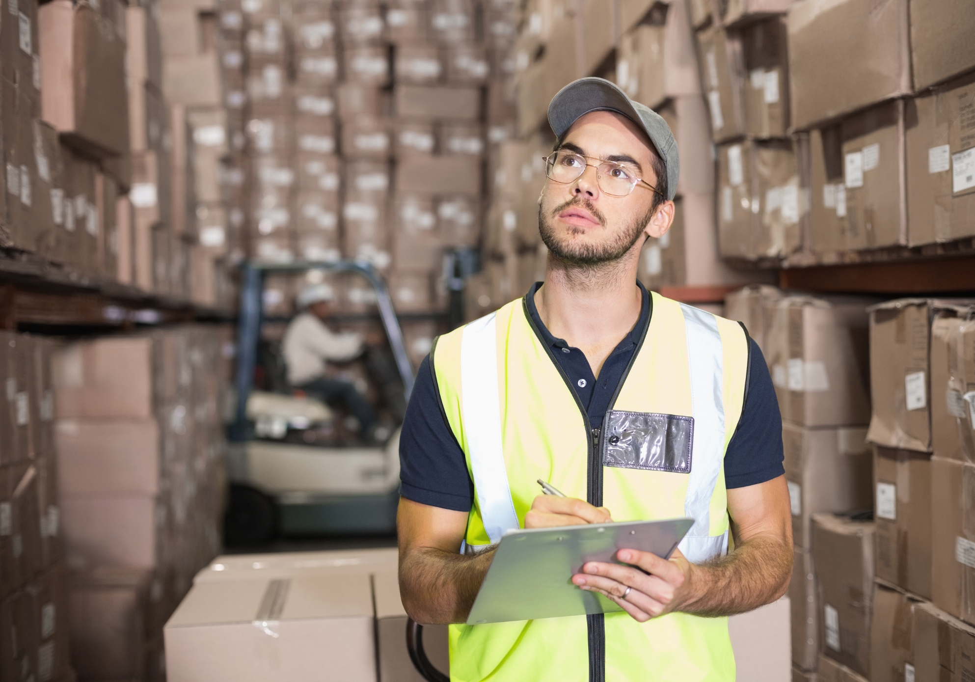 A fire risk assessor wearing a high vis and holding a clipboard while assessing a space using the bs 8674:2025 framework