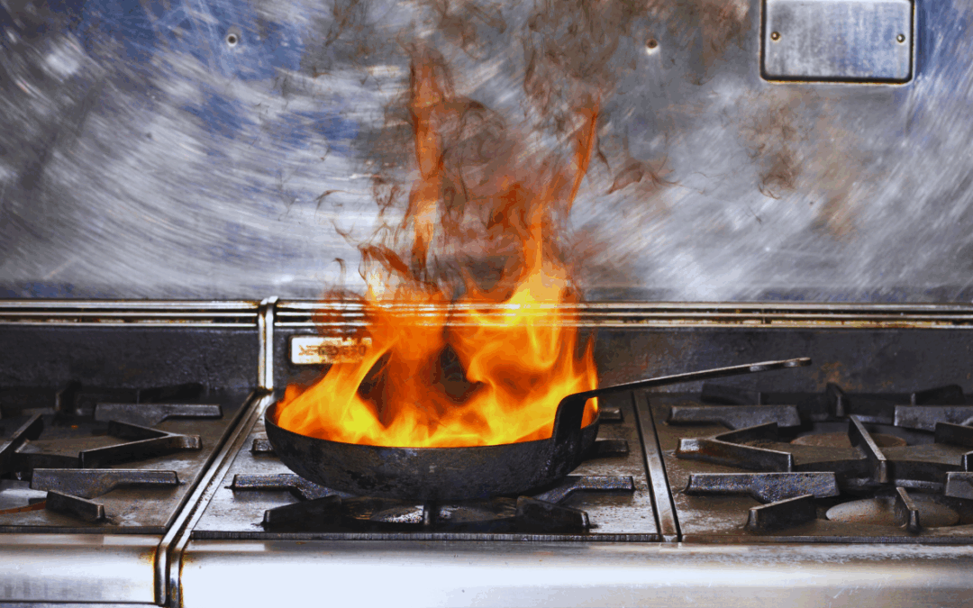 A kitchen fire burning in a frying pan