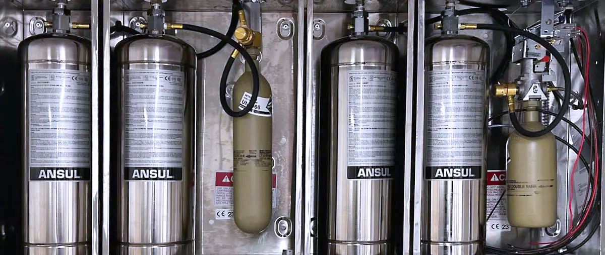 Ansul extinguishing agent cannisters installed in a commercial kitchen
