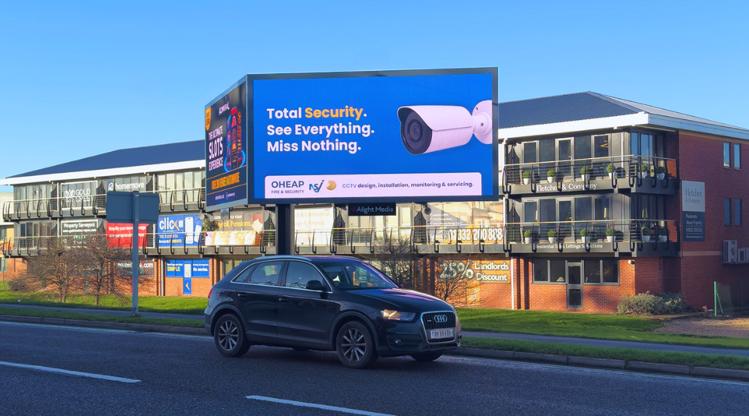 A digital billboard displaying OHEAP Fire & Security's CCTV security system services
