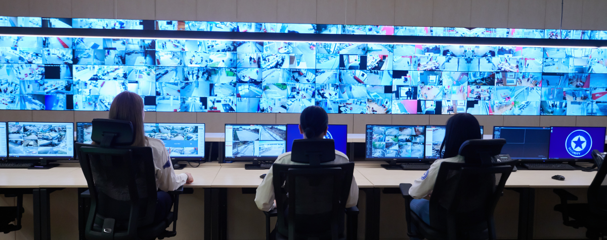 A wall of CCTV screens being monitored