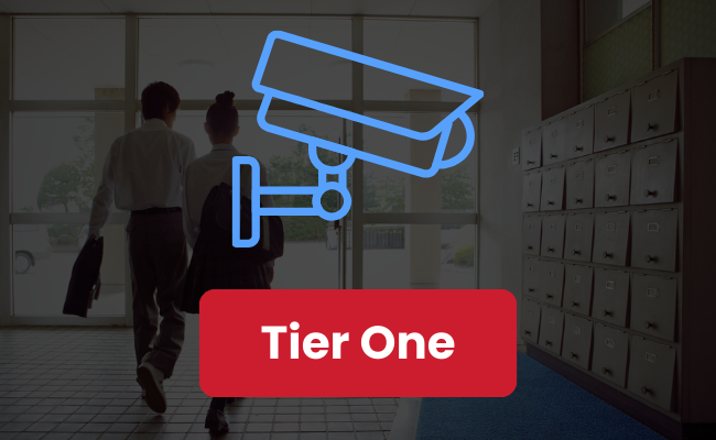 Button showing a CCTV security system icon in front of a school background, highlighting the security requirements for tier one of Martyn's Law