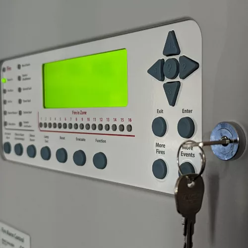 A fire alarm control panel with a key