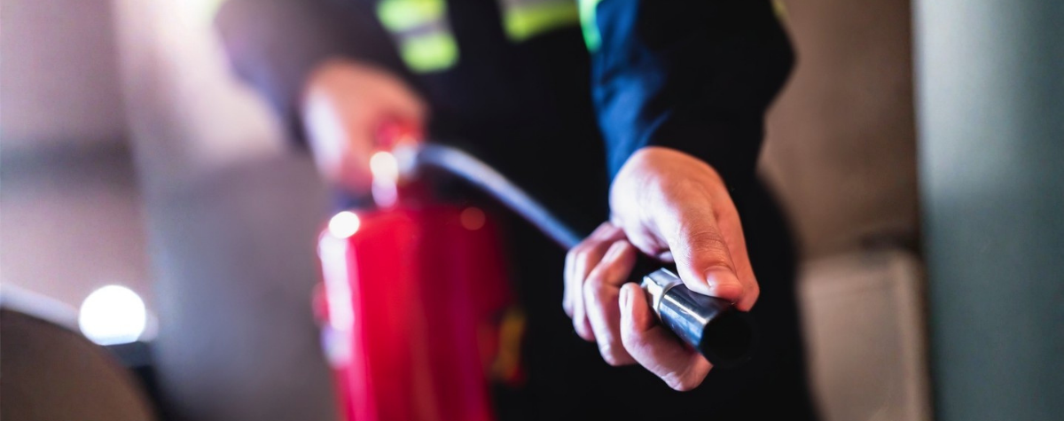A fire warden holding the hose of a CO2 fire extinguisher