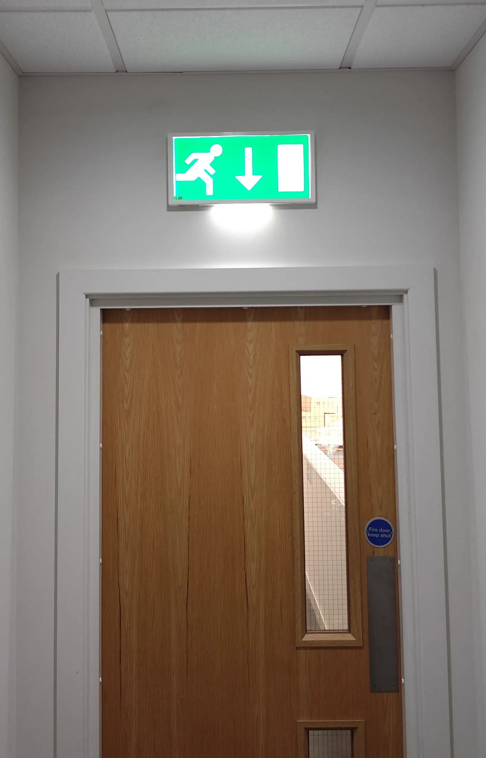 Emergency light illuminated above a doorway